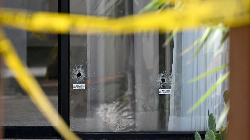 Lubang peluru di kaca jendela vila di Bali, lokasi penembakan yang menewaskan turis asal Australia. Terlihat garis polisi masih terpasang di sekitar tempat kejadian.